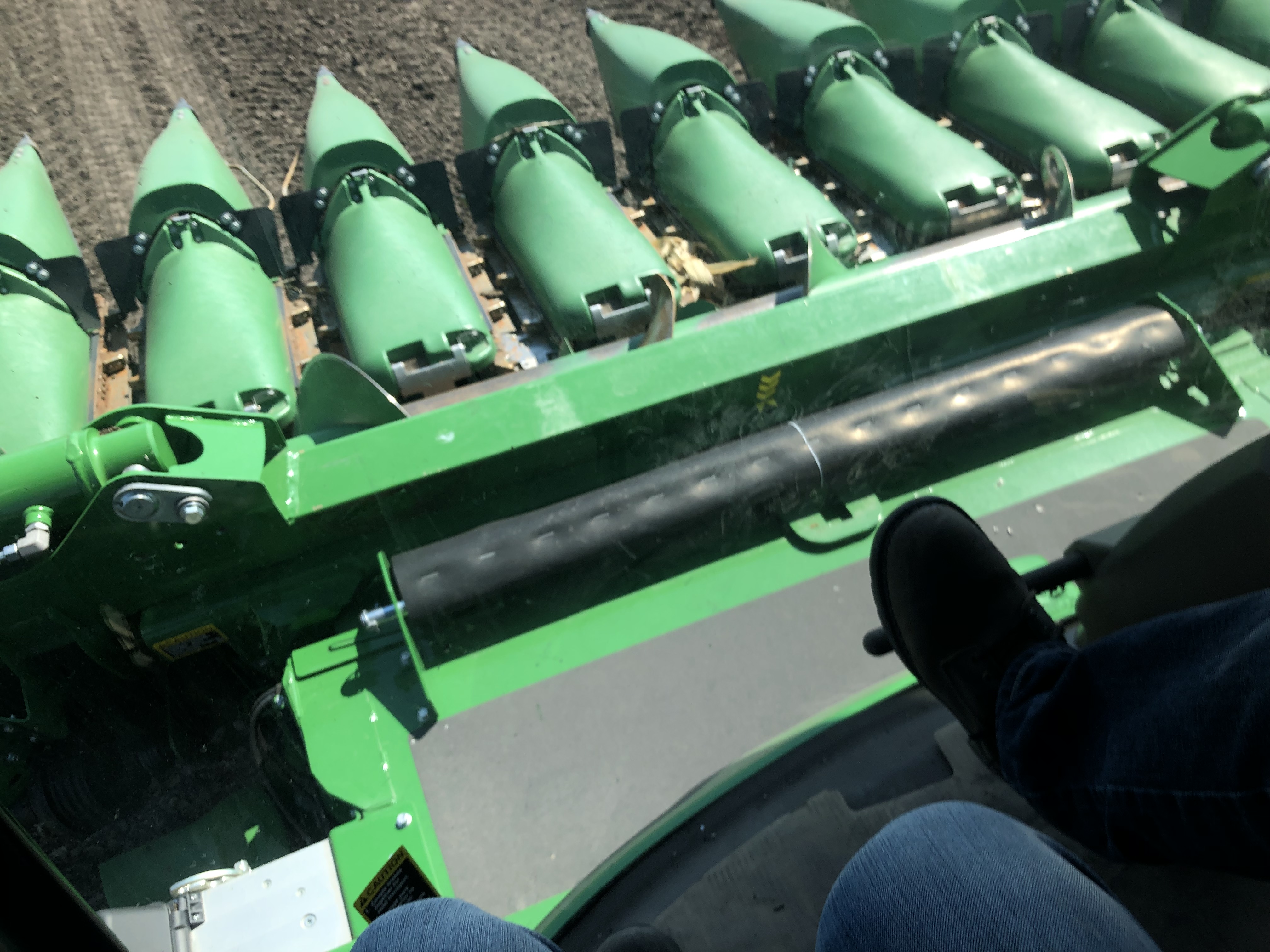 Picture from a combine cab facing down towards the harvest head