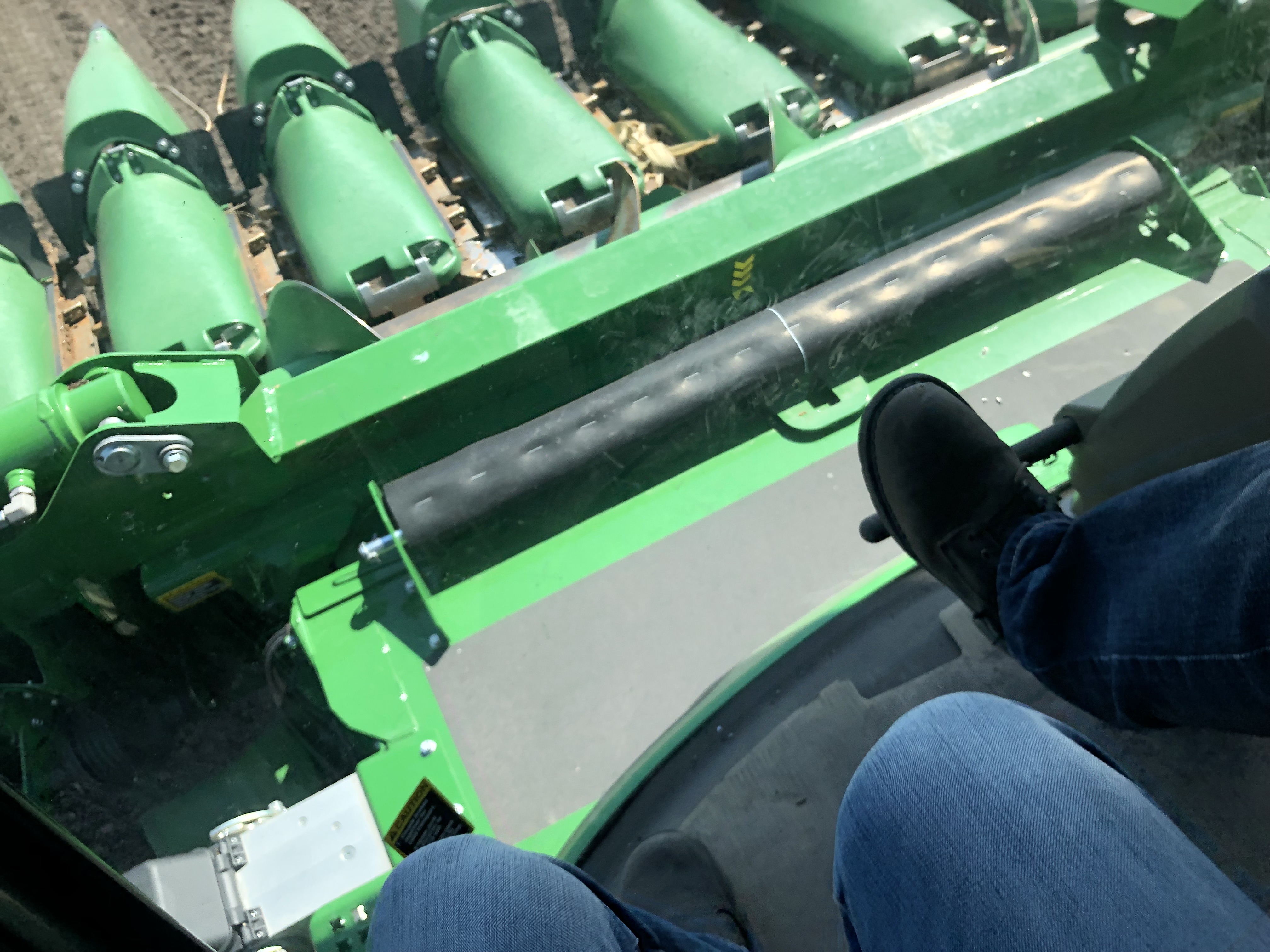 Picture from a combine cab facing down towards the harvest head