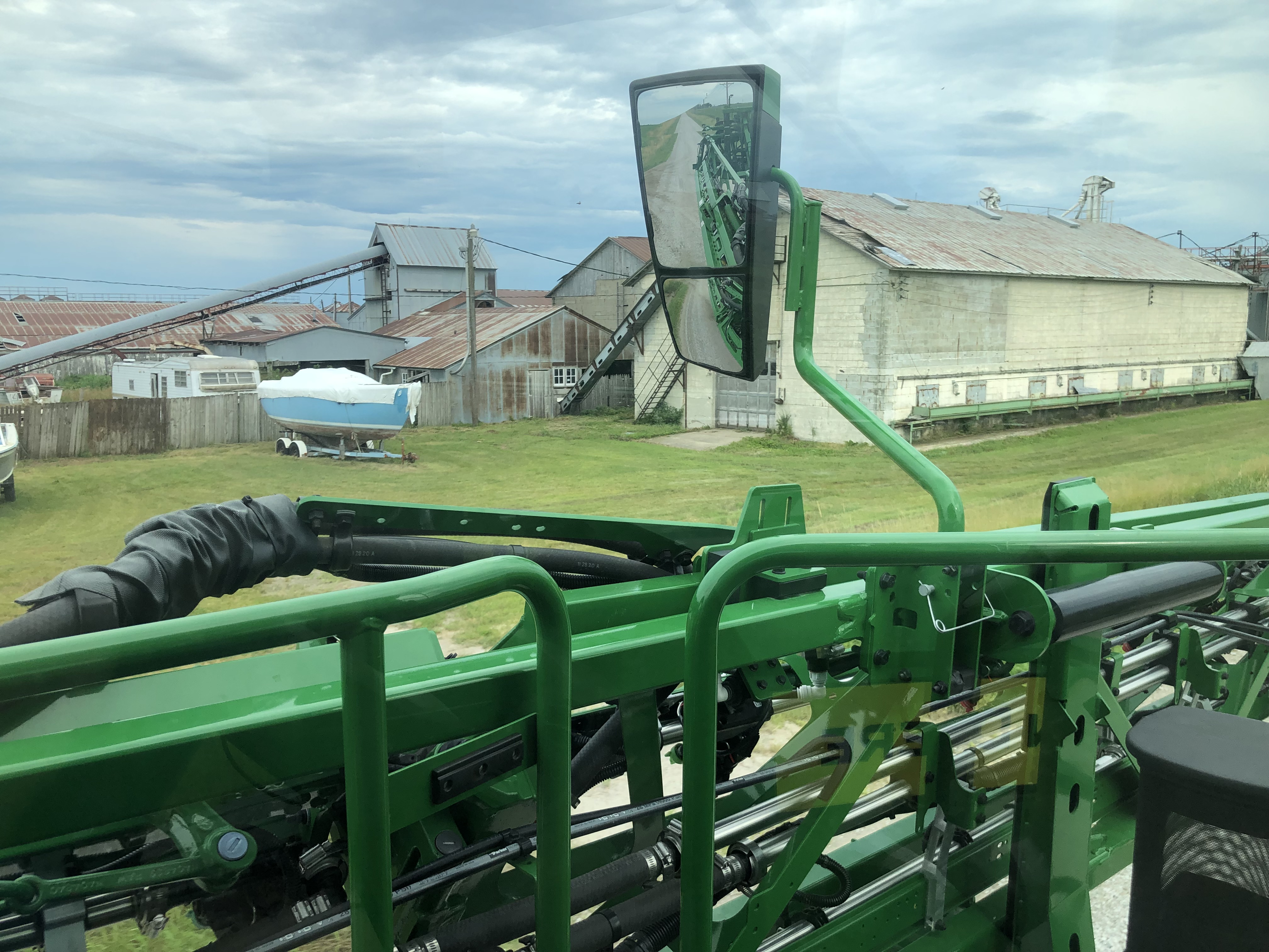 View facing left of the cab of a sprayer while driving down the road in transport mode